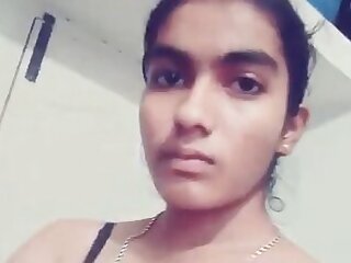 A young and attractive Desi woman records herself in a selfie video